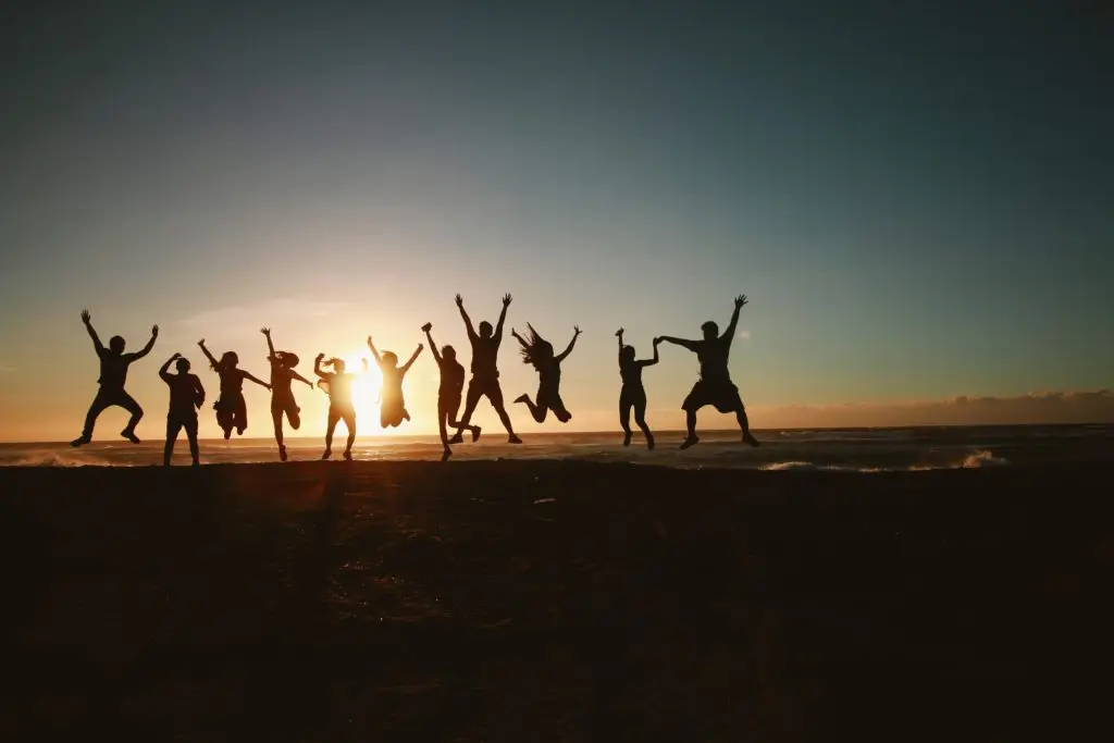 teenagers jumping in the sunset