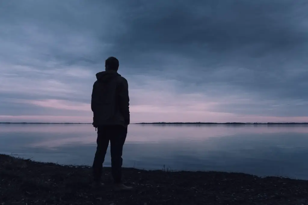 man standing on the ocean side