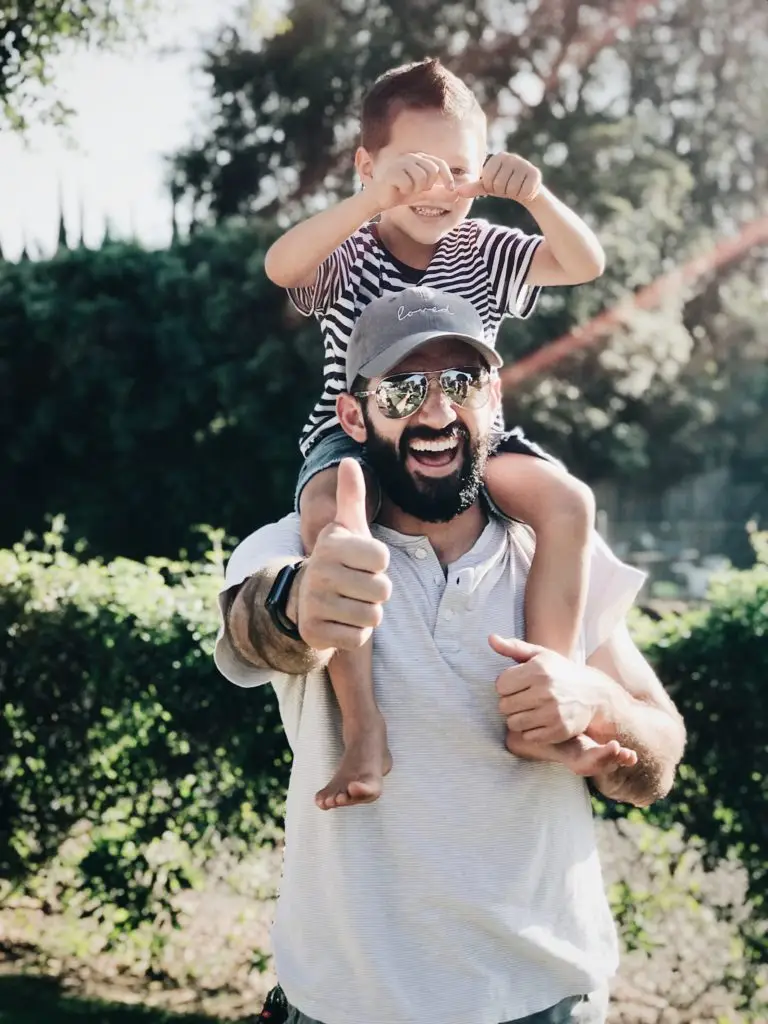 father with son on his shoulders