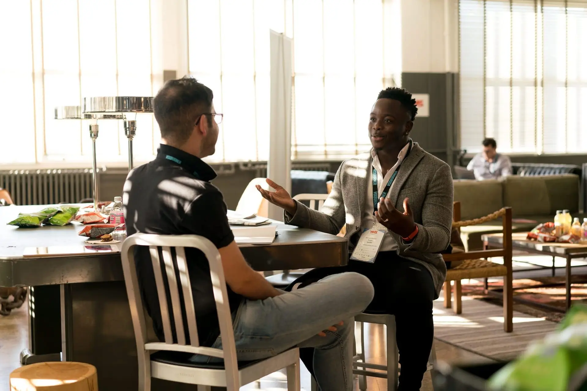 two adults sitting and speaking