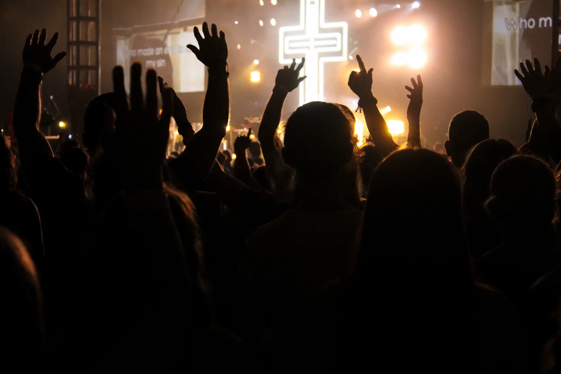 students with lifted hands in worship